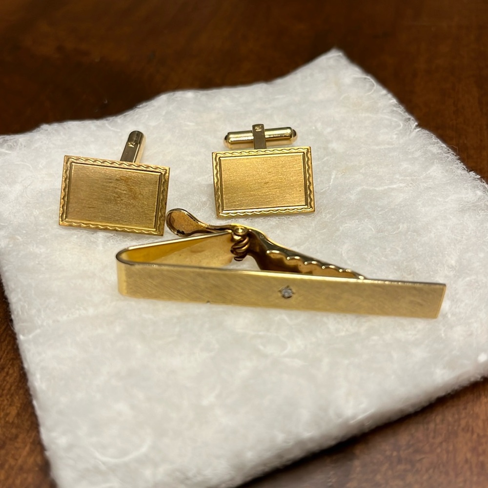 Gold plated tie clip with cubic zirconia and cuff links.